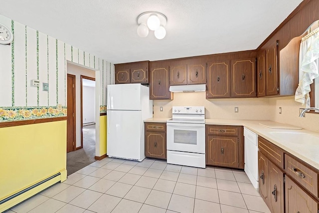 62 Brook St, Wakefield, MA 01880 - kitchen with white appliances, under cabinet range hood, a sink, a baseboard heating unit, and light countertops