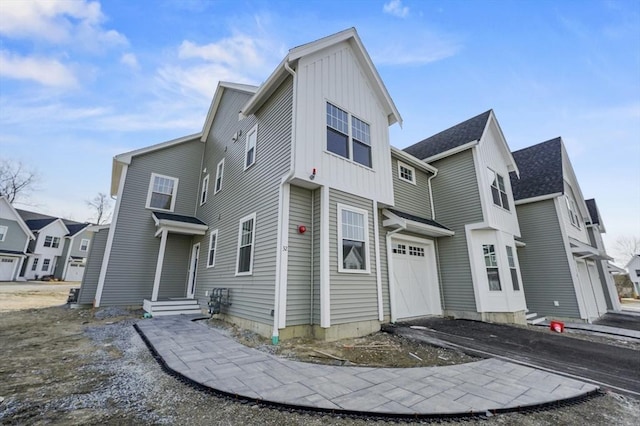 view of front of house featuring a residential view, board and batten siding, and a garage