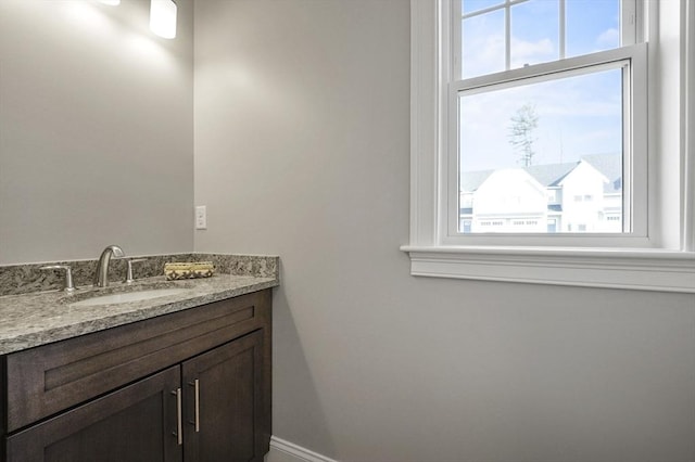 bathroom featuring vanity and baseboards