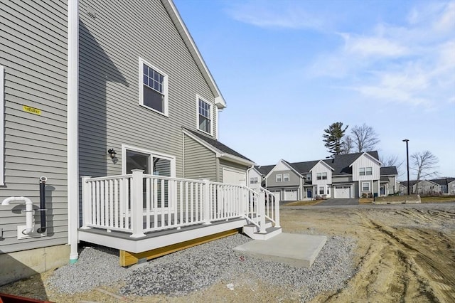 exterior space with a deck and a residential view