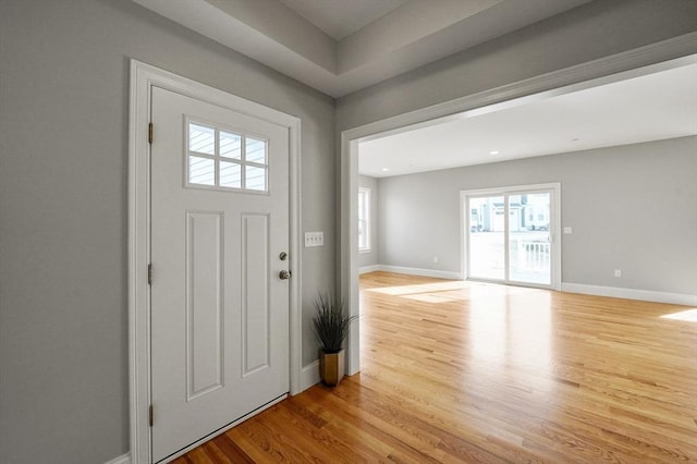 entryway with baseboards and wood finished floors