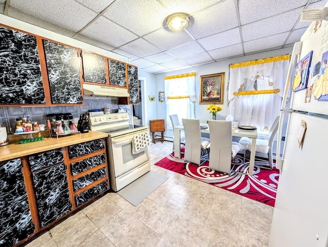 kitchen featuring white appliances, a drop ceiling, light countertops, and under cabinet range hood