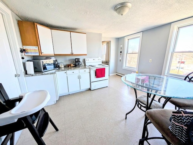 kitchen featuring light floors, a baseboard radiator, electric range, white cabinetry, and stainless steel microwave