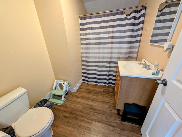 full bath with toilet, vanity, a shower with curtain, and wood finished floors