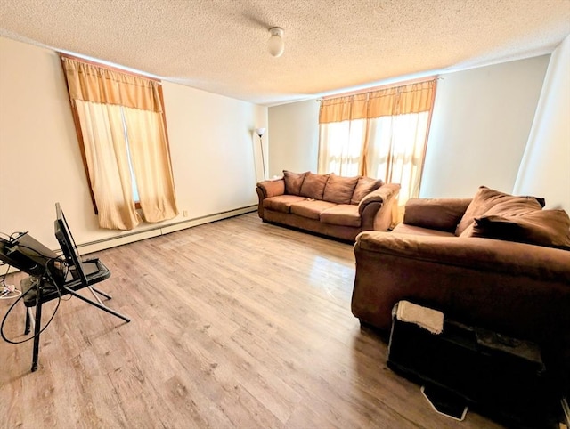 living room featuring a textured ceiling, a baseboard heating unit, and wood finished floors