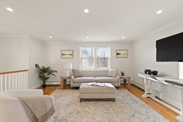 living room featuring baseboard heating, ornamental molding, and light hardwood / wood-style floors