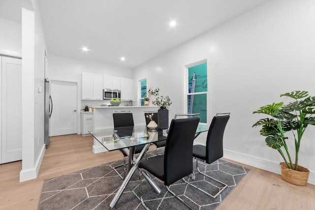 dining space with light hardwood / wood-style floors