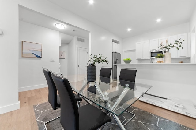 dining space with light wood-type flooring