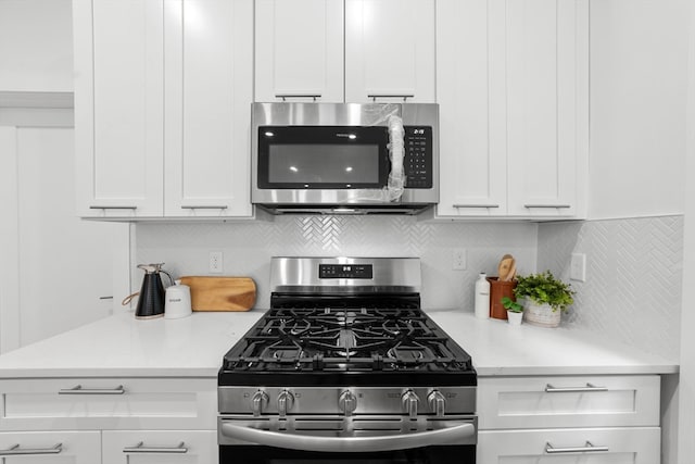 kitchen featuring white cabinets, backsplash, and stainless steel appliances