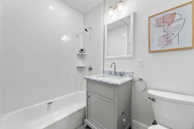 full bathroom featuring tiled shower / bath, toilet, and vanity