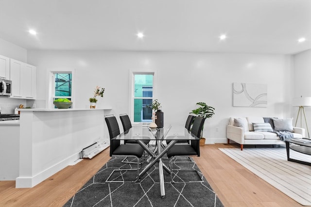 dining area with wood-type flooring and a wealth of natural light