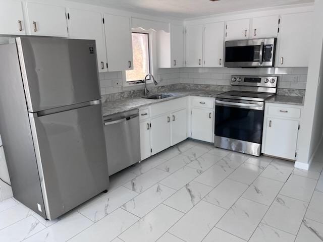 19 Fresh Pond Cir, Plymouth, MA 02360 - kitchen with stainless steel appliances, a sink, white cabinets, and light marble finish floors