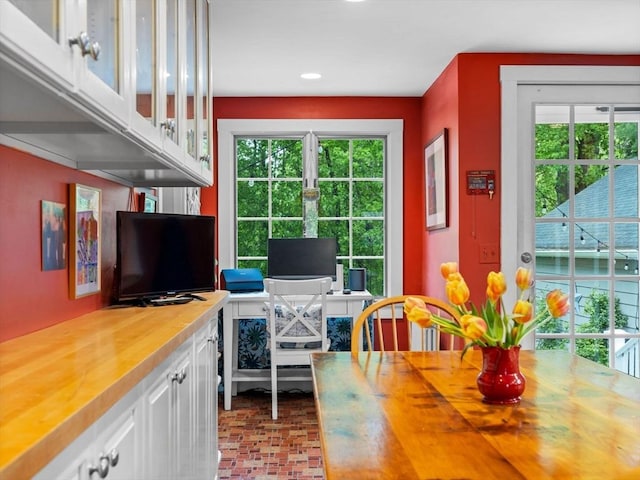 dining room featuring brick patterned floors, a desk, and recessed lighting