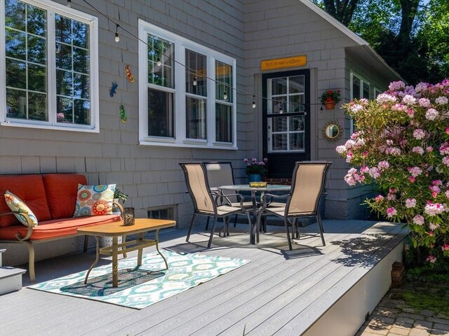 wooden deck featuring an outdoor living space and outdoor dining area