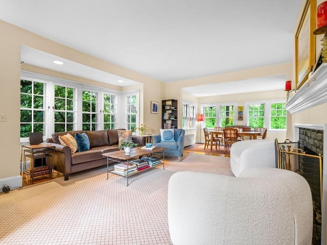 living area with a fireplace, recessed lighting, and baseboards