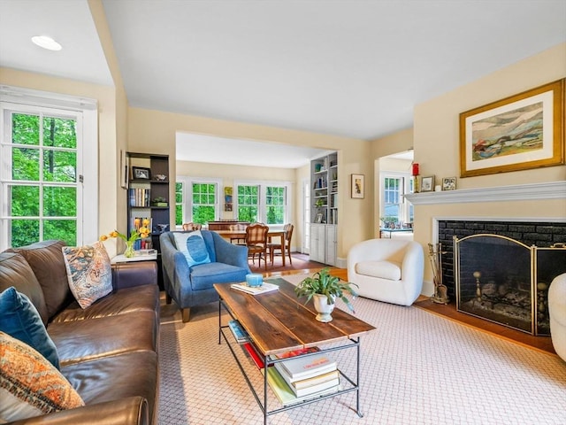 living room featuring plenty of natural light and a fireplace