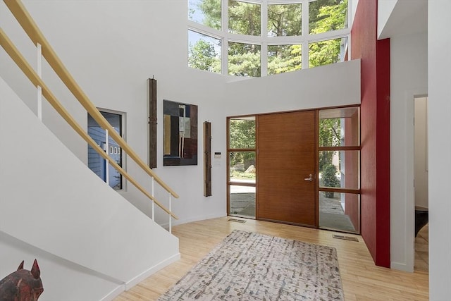 389 River Rd, Carlisle, MA 01741 - foyer with wood finished floors, a towering ceiling, and stairway