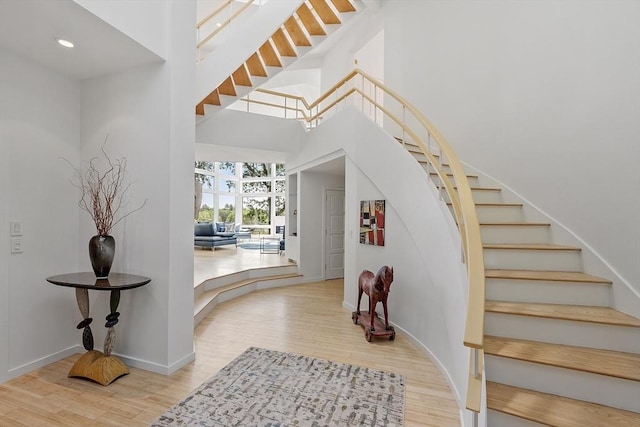 389 River Rd, Carlisle, MA 01741 - entrance foyer with stairway, wood finished floors, recessed lighting, and a towering ceiling