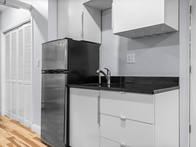 14 Belmont St Unit C, Somerville, MA 02143 - kitchen featuring freestanding refrigerator, light wood-type flooring, white cabinets, and dark countertops