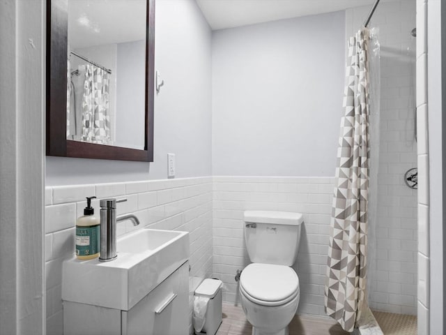 14 Belmont St Unit C, Somerville, MA 02143 - full bath featuring tile walls, a wainscoted wall, a tile shower, and vanity