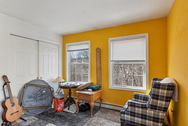 living area with a baseboard radiator and baseboards