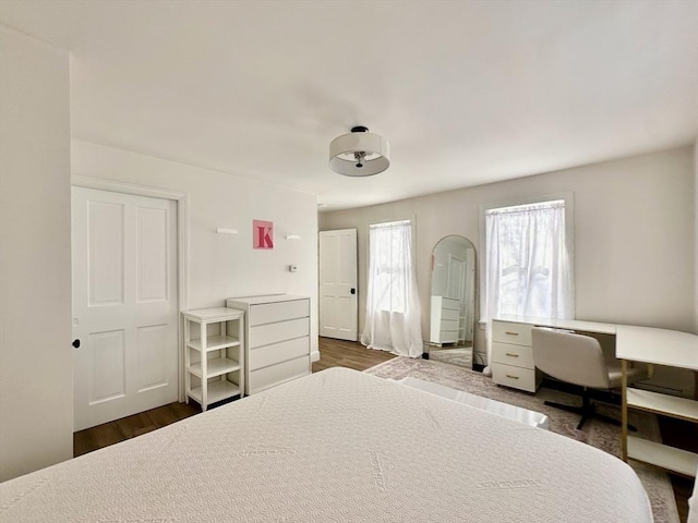 bedroom with dark hardwood / wood-style flooring