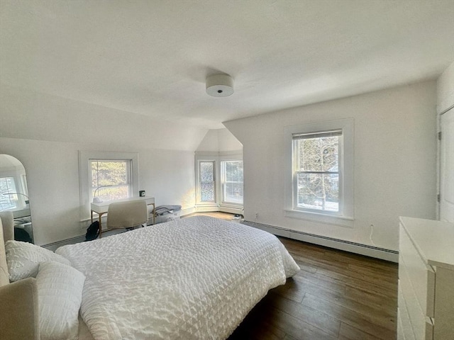 bedroom featuring a baseboard radiator, lofted ceiling, and dark wood-type flooring