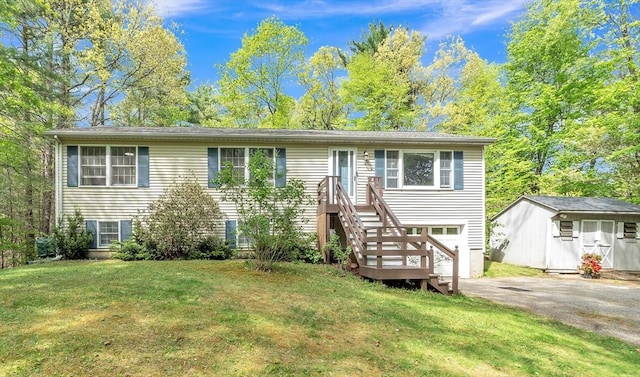 view of front of home with a front yard, driveway, and an outbuilding