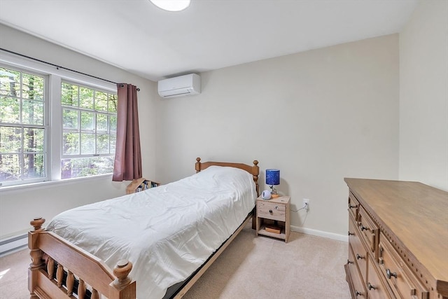 bedroom with a wall unit AC, light colored carpet, and baseboards