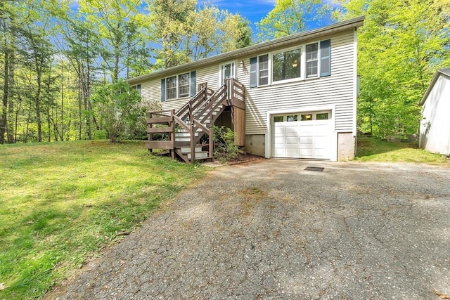 view of front facade with driveway, a front lawn, and a garage
