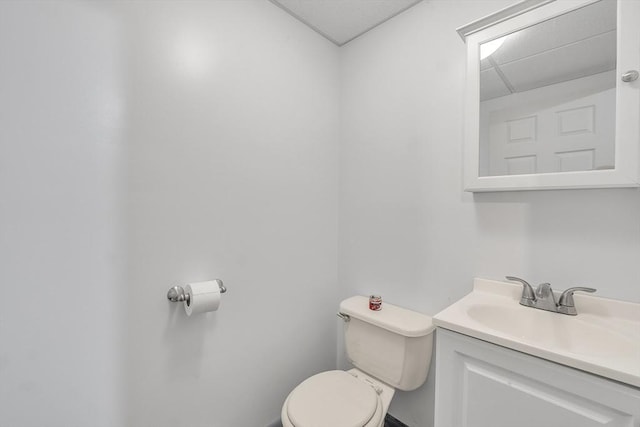 half bath featuring toilet and vanity