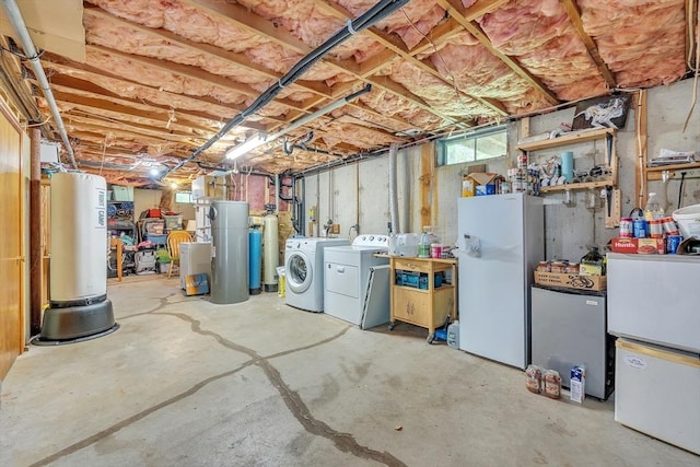 basement featuring separate washer and dryer, freestanding refrigerator, and a water softener