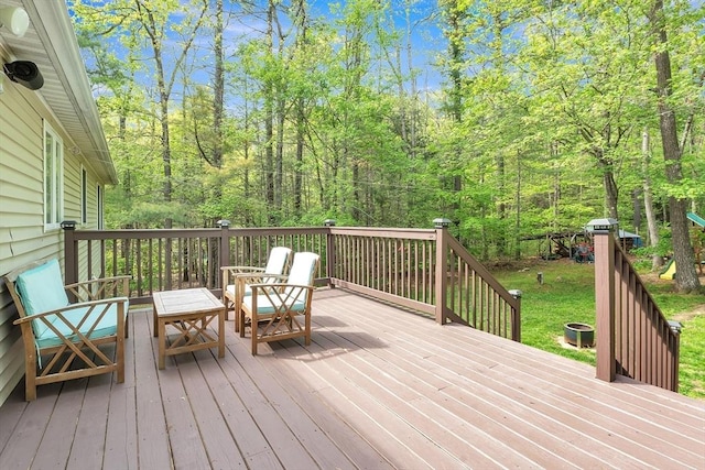 wooden terrace featuring a wooded view