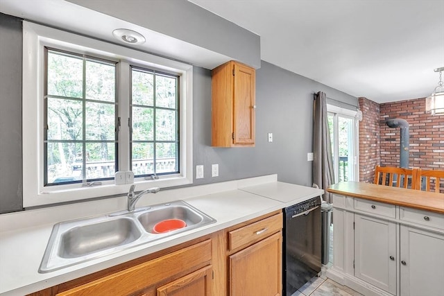 kitchen with dishwasher, a sink, a wood stove, light countertops, and decorative light fixtures