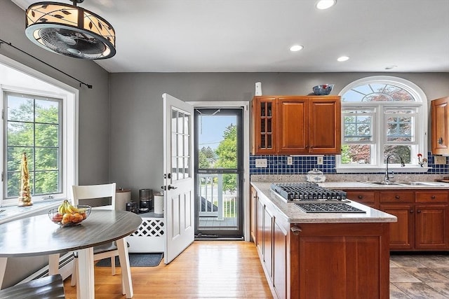 75 Hillcroft Ave, Worcester, MA 01606 - kitchen with a sink, brown cabinets, recessed lighting, decorative backsplash, and stainless steel gas cooktop