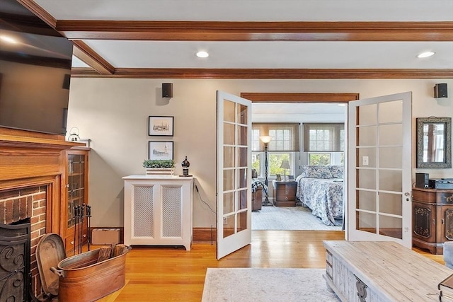 75 Hillcroft Ave, Worcester, MA 01606 - living room with french doors, wood finished floors, ornamental molding, a brick fireplace, and baseboards