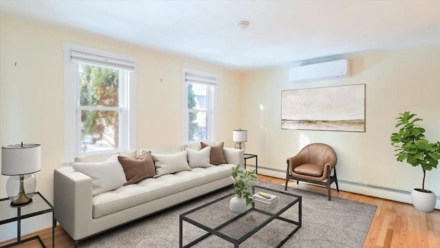 living room with hardwood / wood-style floors, a wall unit AC, and a baseboard heating unit