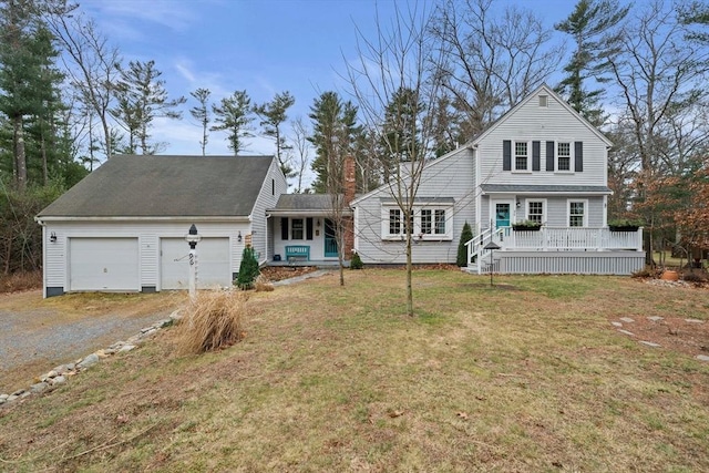 front facade with a front yard, a garage, and covered porch