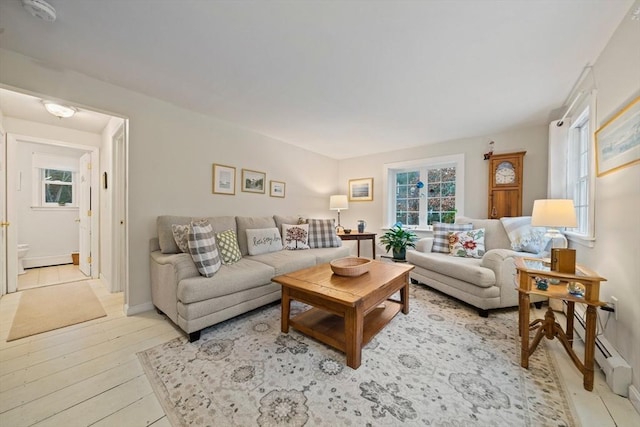 living room featuring baseboard heating and light wood-type flooring