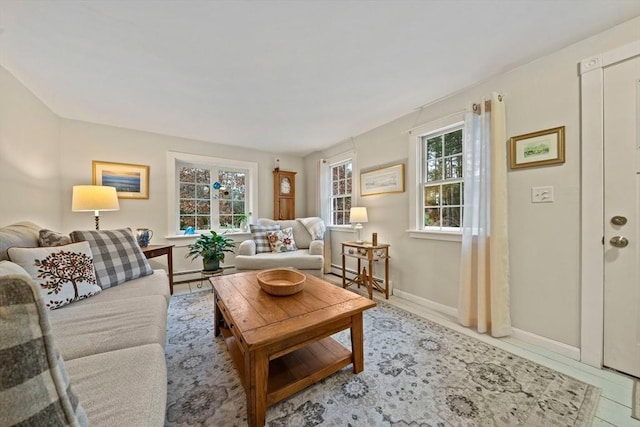 living room with tile patterned floors and a baseboard heating unit