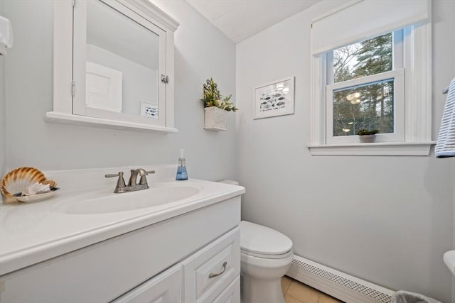 bathroom with tile patterned floors, vanity, toilet, and a baseboard heating unit