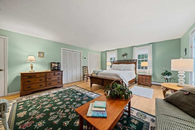 bedroom featuring a baseboard radiator and light wood-type flooring