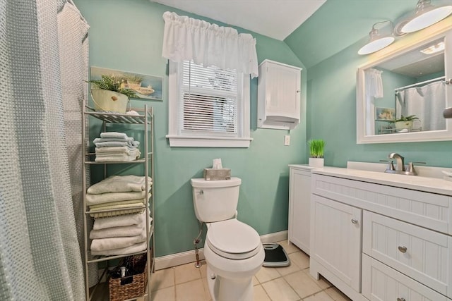 bathroom with tile patterned floors, vanity, toilet, and vaulted ceiling