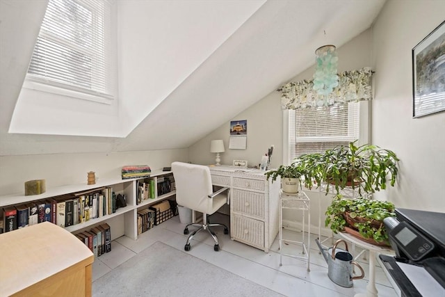 tiled office featuring vaulted ceiling and a chandelier