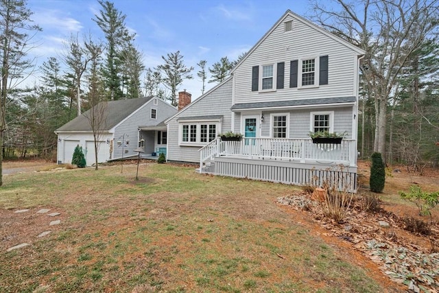 back of property featuring a garage and a yard