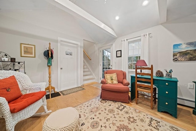 sitting room featuring light hardwood / wood-style floors, vaulted ceiling, and a baseboard radiator