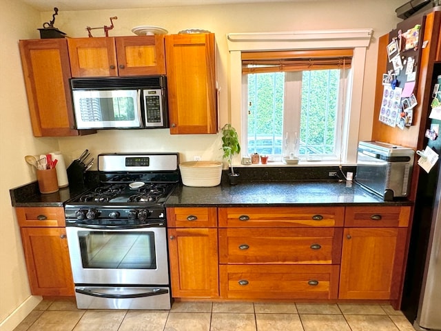 kitchen with appliances with stainless steel finishes and light tile patterned floors