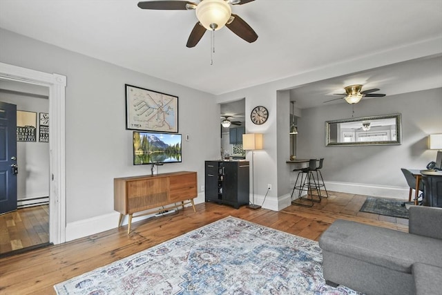 160 Regan St, Gardner, MA 01440 - living area with a ceiling fan, hardwood / wood-style flooring, and a baseboard heating unit