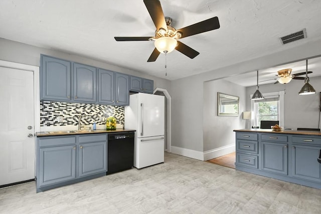 160 Regan St, Gardner, MA 01440 - kitchen featuring dishwasher, freestanding refrigerator, and blue cabinetry