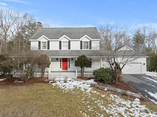 view of front of property with driveway, a garage, a chimney, roof with shingles, and a porch